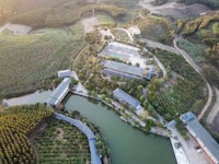 a bird's eye view of a farm and pond